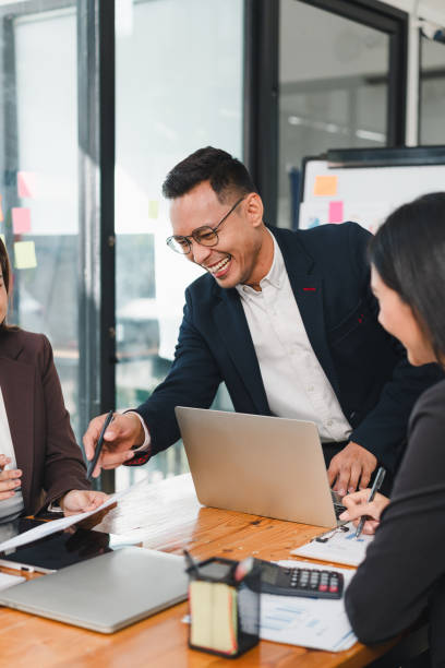 istock group of professionals engaged in lively discussion during meeting, showcasing teamwork and collaboration. atmosphere is positive and productive 2187367025