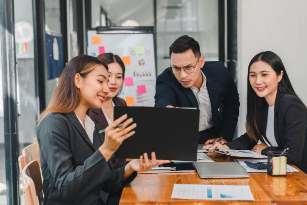 istock Professional team collaborating in modern office, discussing project details and sharing ideas. atmosphere is focused and engaging, showcasing teamwork and communication 2187367043