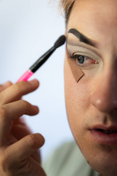 istock Drag queen applying eyeshadow with a brush and adhesive tape 2187368598