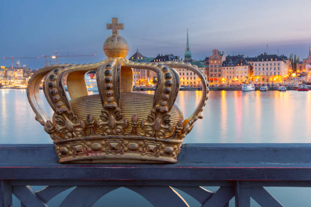 Scenic view of Stockholm waterfront at dusk showing illuminated historic buildings and the spire of Storkyrkan church, Stockholm, Sweden