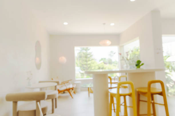 Blurry background interior design bar table chair window decorate indoors space display. Blurred background cafe coffee shop restaurant in shopping mall with light bokeh business event retail store
