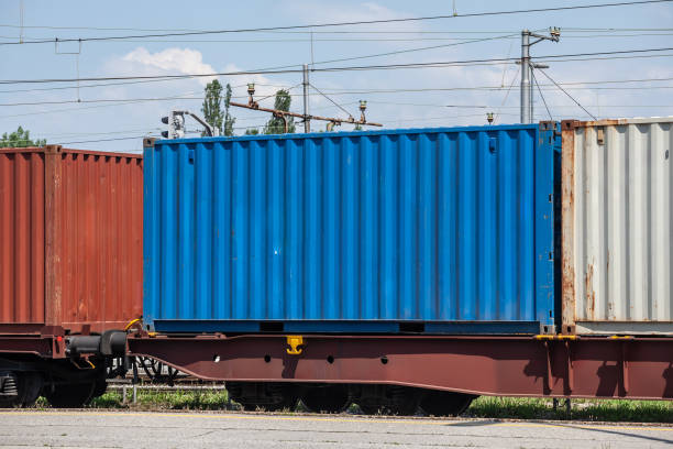 istock A blue shipping container loaded on a train, illustrating intermodal transport and the logistics industry. 2187372613