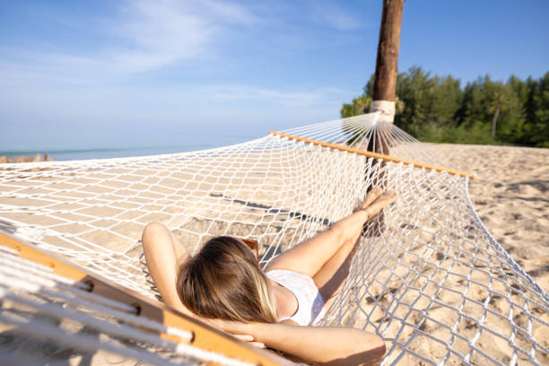 istock Woman Relaxing on Beach Hammock in Sunny Weather 2187372751