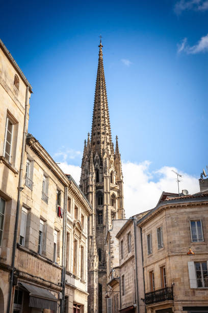 A captivating view of the Basilique Saint Michel's tower dominating the old town of Bordeaux, France. This iconic Gothic basilica is a testament to the city's rich history and architectural heritage. The photograph captures the intricate details of the basilica's spire, set against the backdrop of Bordeaux's traditional rooftops and narrow streets. The scene reflects the charm of European architecture and the significance of religious landmarks in shaping the cultural landscape of historic cities like Bordeaux.