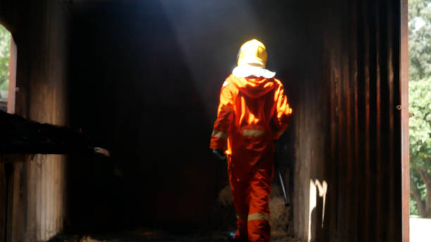 istock Firefighter Rescue team training in fire fighting extinguisher. Teamwork Firefighter fighting with flame using fire hose chemical water foam spray engine. Fireman teams wear hard hat safety uniform 2187374781