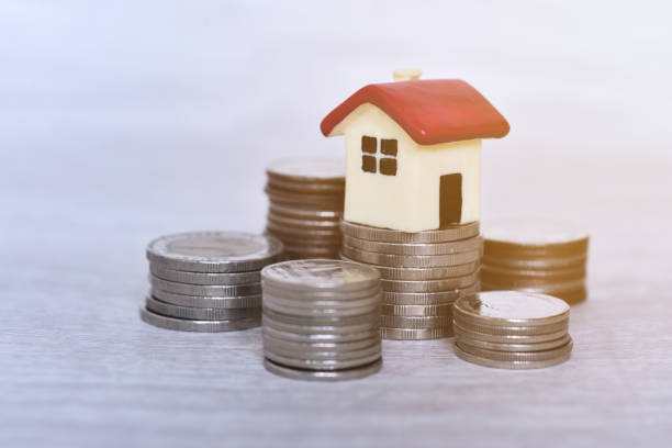 istock Red roof house on the stacking coins with white background 2187378135