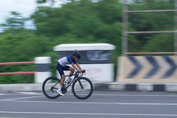 Tasikmalaya, Indonesia, November 27, 2024 - A photo of a man riding a bicycle