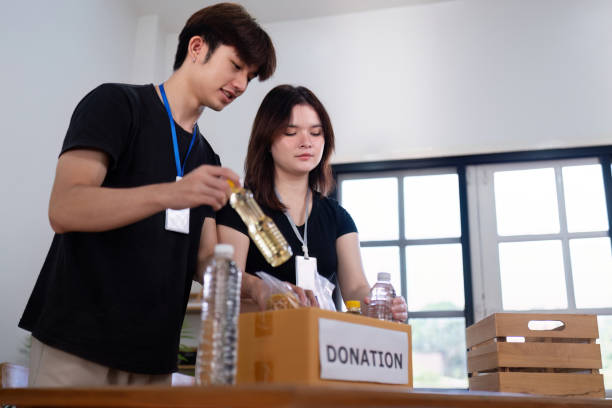 istock Volunteers Sorting Items for Donations at Charity Event 2187380807