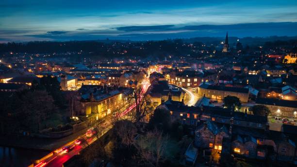 istock Charming town at dusk with vibrant streetlights. 2187381388