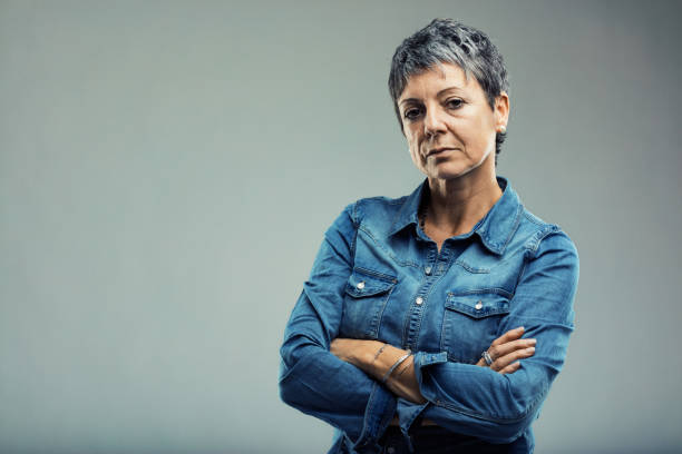 istock Serious mature woman with folded arms expressing disappointment 2187381874