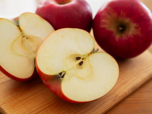 istock Fresh Ripe Red Apple on A Wooden Cutting Board 2187381990