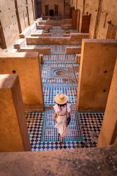 istock Woman exploring Moroccan palace with intricate tiles. 2187382561