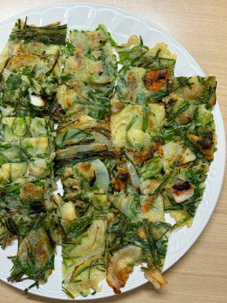 Pajeon is a savory Korean pancake made with green onions (pa) in a light batter, often mixed with seafood like squid or shrimp. Crispy on the outside and soft inside, it’s a flavorful snack or side dish, perfect with dipping sauce and enjoyed during rainy days. pajeon is a savory korean pancake made with green onions (pa) in a light batter, often mixed with seafood like squid or shrimp. crispy on the outside and soft inside, it’s a flavorful snack or side dish, perfect with dipping sauce and enjoyed during rain