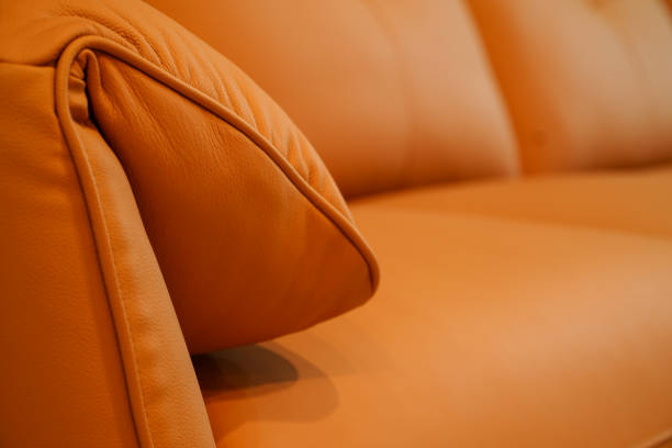 Comfortable orange leather sofa and with real soft morning sunlight  from the back window. Lifestyle concept.