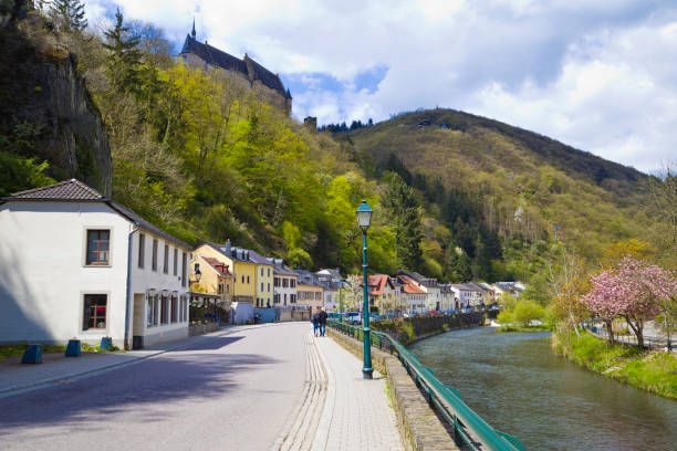 Peaceful scene of a narrow path lined with stone walls and colorful buildings in Luxembourg's historic old town.