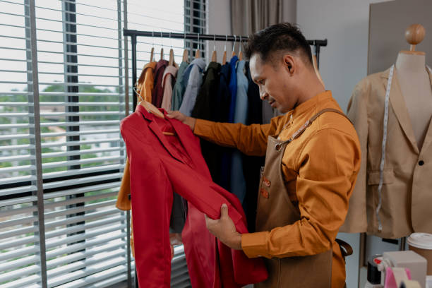 istock a designer is working in his studio, checking all clothes before sent to shop, talented designer is happy with his work, stylish. fabric, sewing, fashionable, entrepreneur 2187389972
