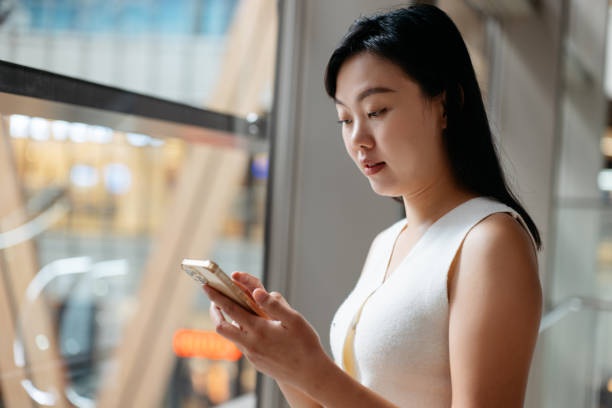 istock Asian businesswoman using her smartphone in office 2187395296