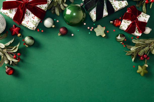 istock Elegant Christmas composition with gift boxes, ornaments, confetti on green background with copy space. Top view, Flat lay. Xmas banner mockup, chic greeting card template 2187396062