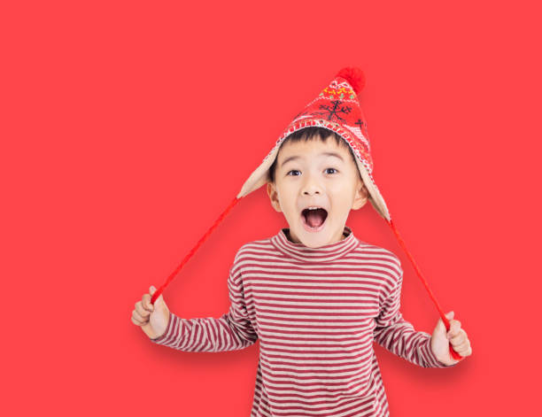 istock Suprised  asian  Kid Dressed as Santa isolated on red 2187396732