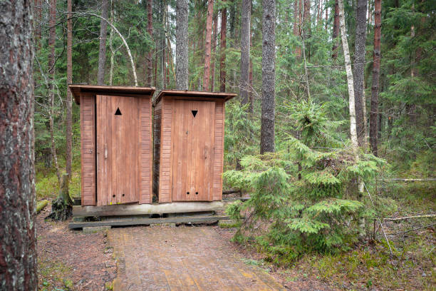 istock .Two identical wooden facilities in the forest on the trail 2187397051