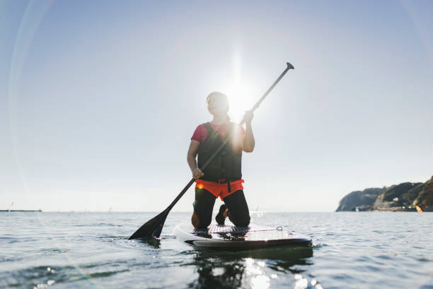 istock Japanese woman playing standup paddle boarding 2187397384