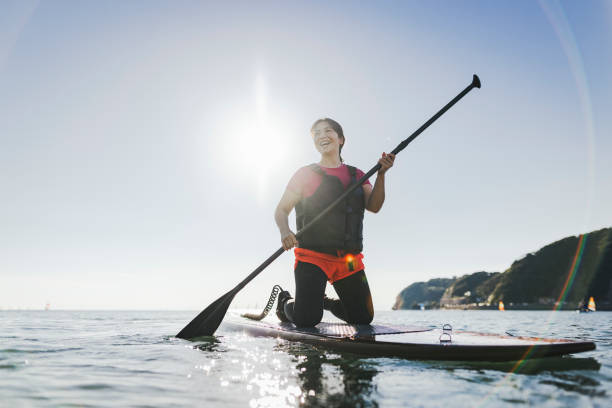 istock Japanese woman playing standup paddle boarding 2187397388
