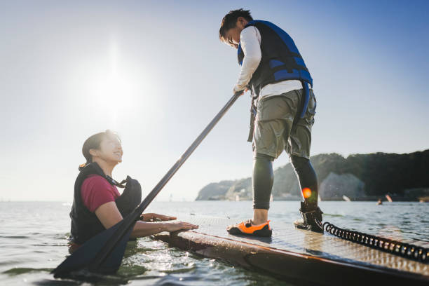 istock Mother and son playing stand up paddle boarding. 2187397408