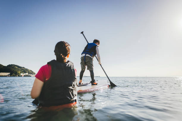 istock Mother and son playing stand up paddle boarding. 2187397410