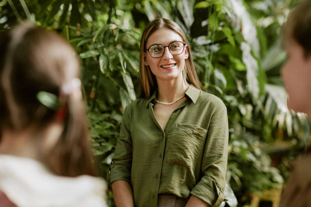 Cheerful Female Botanist Working With Kids