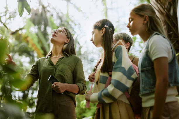 istock Botanist Telling About Plants Growing In Glasshouse 2187400839