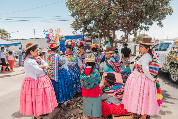 Moquegua, Peru - November 25, 2024 - Parade of traditional dances in southern Peru on a very hot day. Group of women dressed in traditional local clothing, waiting for the event to begin.
