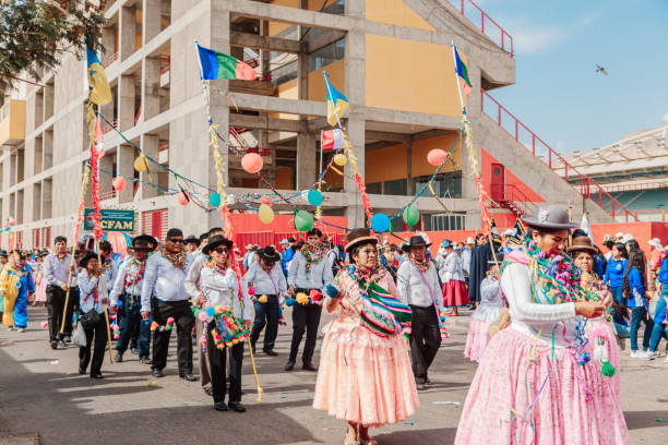 Moquegua, Peru - November 25, 2024 - Parade of traditional dances in southern Peru on a very hot day. Women dressed in Andean clothing adorned with carnival elements.