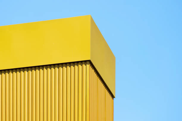 istock orange wall of a modern building against a blue sky 2187403417