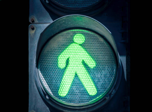 istock traffic light with a green man on a black background 2187403683