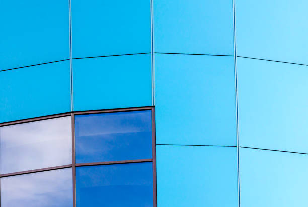istock wall of the building with blue panels and a mirrored window 2187404284