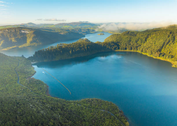 istock Overhead view of lake surrounded by lush foliage. 2187407204
