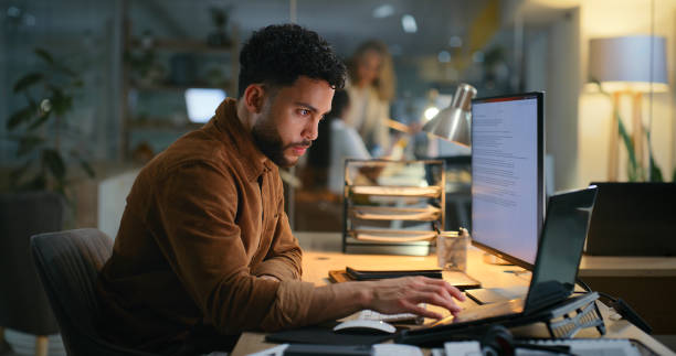 istock Office, night and businessman with laptop for research, online information and solution for startup. Browse, male employee or digital marketing specialist with computer for seo, keywords or web tools 2187408505