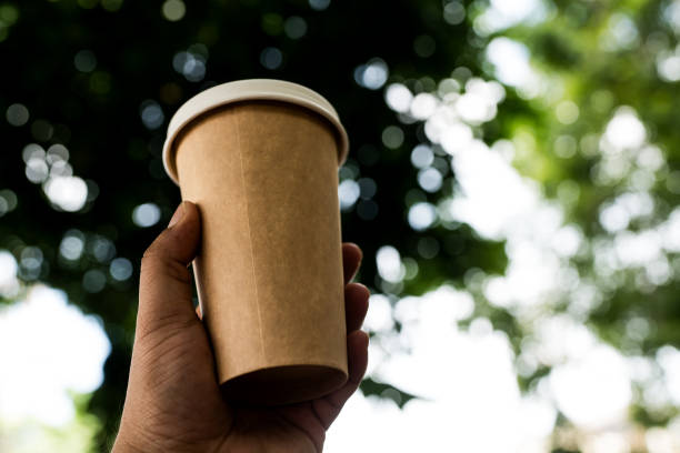 istock Take away coffee cup on a nature blur background 2187410206