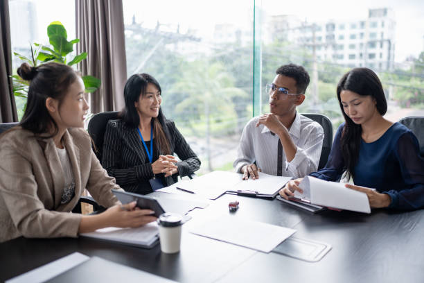 istock Sales manager giving advice application form document, considering mortgage loan offer for car and house insurance. 2187410297