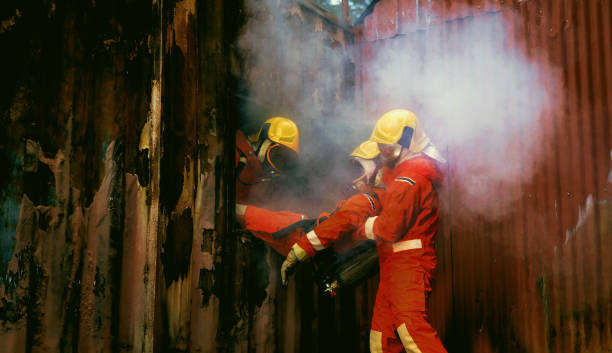 istock Two firefighters in red and yellow suits are spraying water on a wall 2187411072