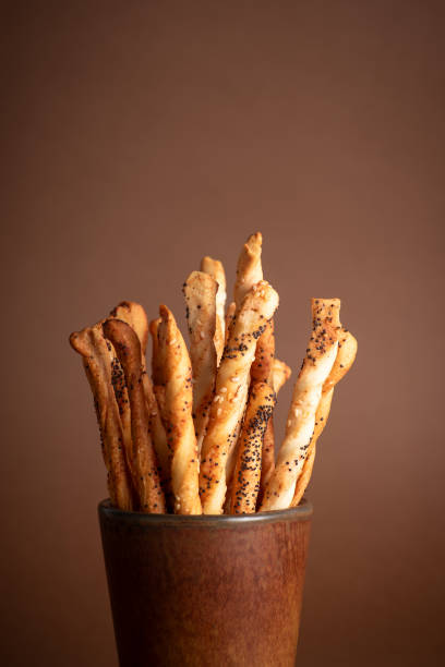 Soft, warm bread rolls topped with sesame seeds are freshly baked.