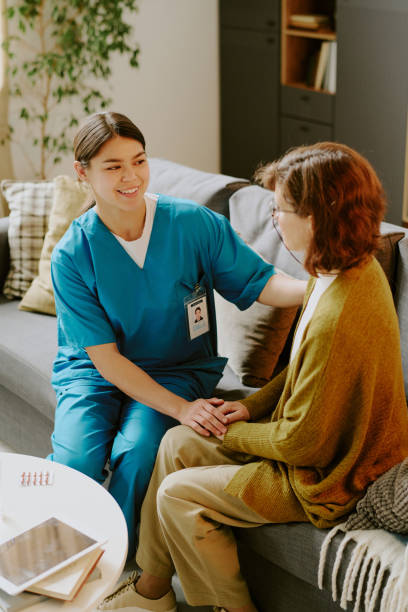 Smiling Nurse Comforting Patient in Home Setting