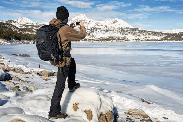 istock mountaineer taking photo with her smartphone in Pyrenees mountains 2187414431