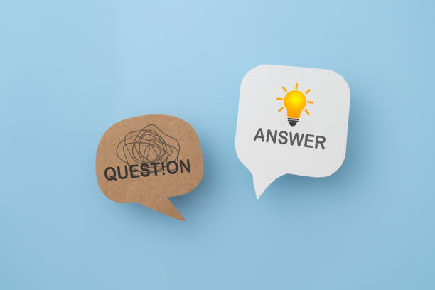 istock tangle of thoughts and bright lightbulb sign with text,  on real speech speech bubble paper cut on blue background, for FAQ , Frequently asked questions, mental health concept 2187416029