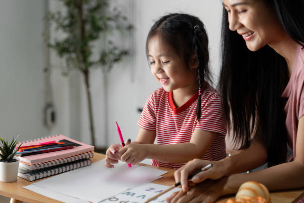 istock Joyful Child Engaged in Learning with Parent, Exploring Letters and Numbers in a Creative Home Environment 2187418030