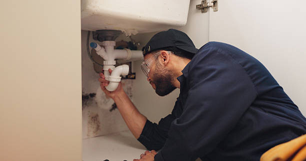 istock Plumber, man and pipeline installation in kitchen with safety for home maintenance or fixing leak by sink. Plumbing contractor, handyman or working on filter system repair for small business in house 2187421649