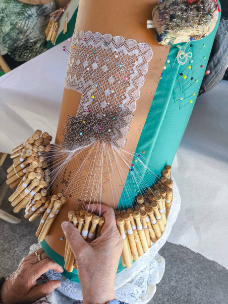 Close-up of woman hands works with bobbin lace, hand made crafting Laces