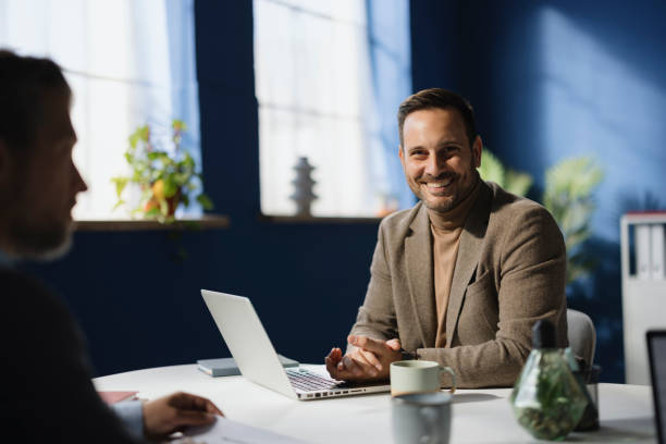 istock Happy businessman working on laptop in the office. 2187423349
