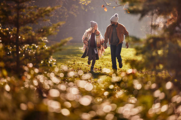 istock Carefree couple having fun while running in autumn day. 2187423532