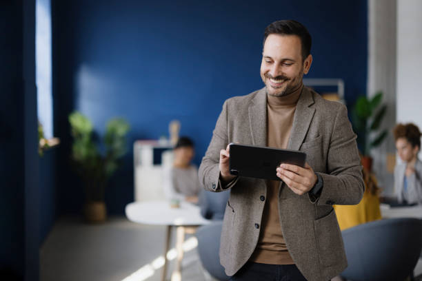 istock Happy businessman working on touchpad in the office. 2187423926